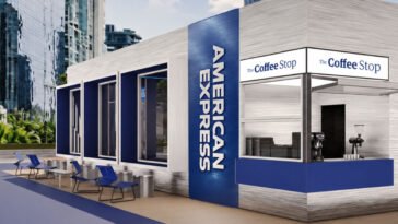 Estrutura azul e branca da American Express com cafeteria The Coffee Stop, janelas amplas e mesas externas.