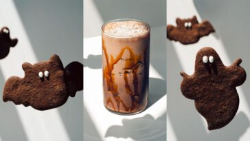 Montagem com biscoitos escuros em formato de morcego e fantasma e bebida gelada cremosa com calda nas paredes do copo.